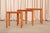A set of three Danish modern nesting side tables in teak with ceramic tile inset tops, a practical and visually warm...