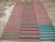 This Mid-20th century Turkish Flatweave Kilim rug, presents a lively striped design that embodies the bold color...