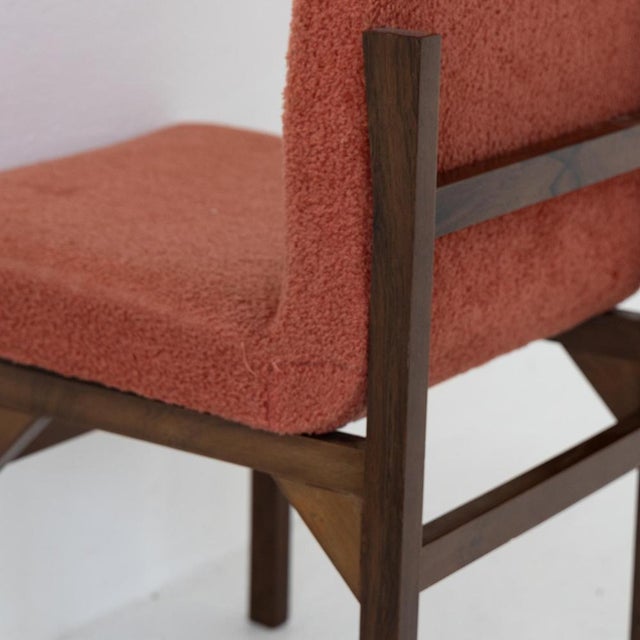 Set of six vintage chairs with a slender, sculptural silhouette, made with a teak wood frame and original red bouclé...