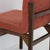 Set of six vintage chairs with a slender, sculptural silhouette, made with a teak wood frame and original red bouclé...