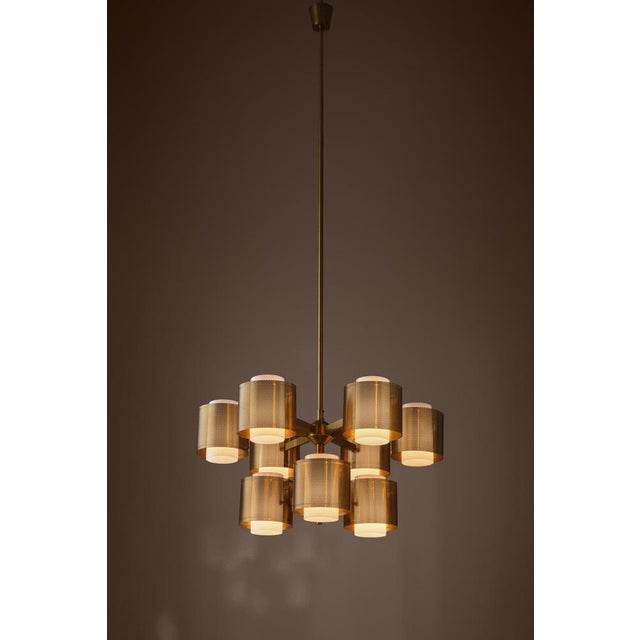 Rare model, produced in Sweden, 1960s. Perforated brass and acrylic shades. Please note: height is adjustable after your...