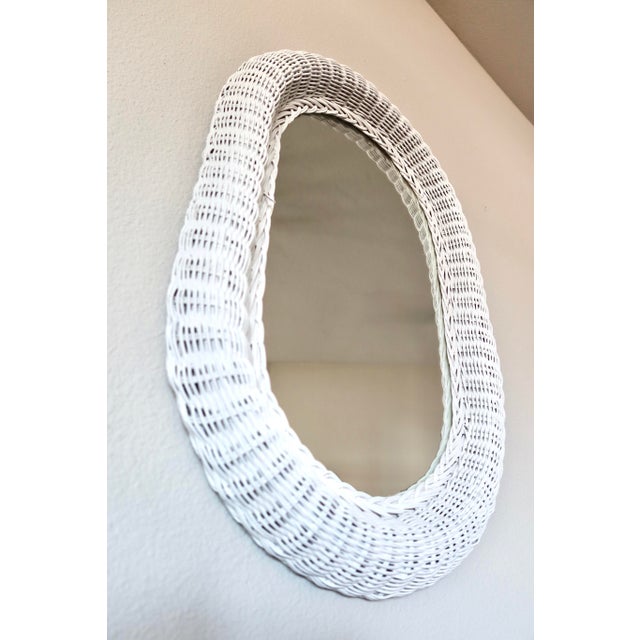 Large vintage oval mirror in a woven white wicker frame. Wicker mirrors like this were a staple of coastal and sunroom...