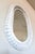 Large vintage oval mirror in a woven white wicker frame. Wicker mirrors like this were a staple of coastal and sunroom...