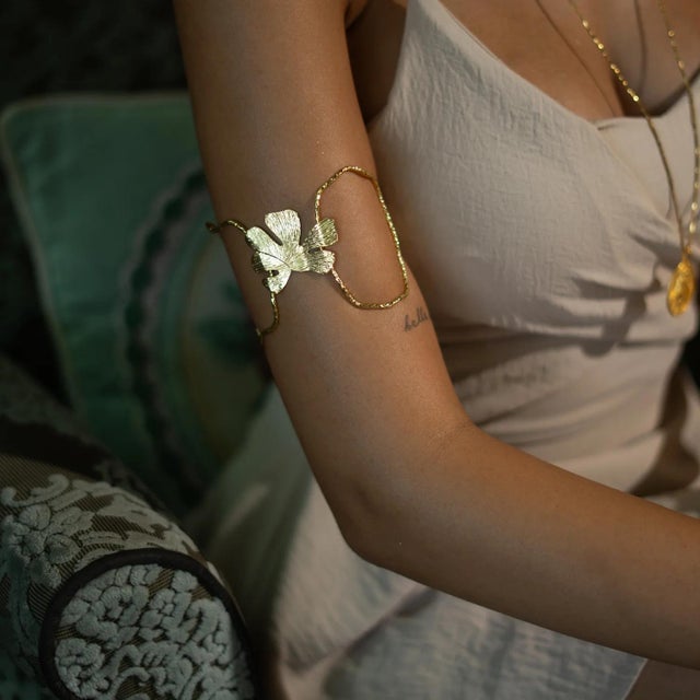 Celebrate the beauty of nature with the Eternal Leaves Gold Arm & Cuff Bracelet. Handcrafted from bronze and plated with...