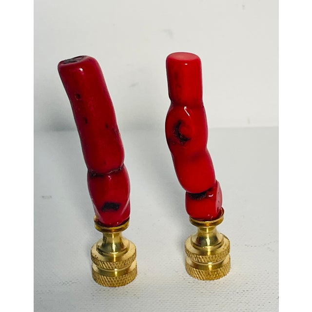 Fabulous red coral branches mounted on brass bases as lamp finials.