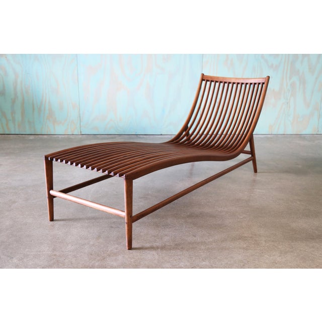 A sculpted cherry chaise lounge chair Attributed to Christophe Pillet (French b. 1959). An elegant floating body of curved...