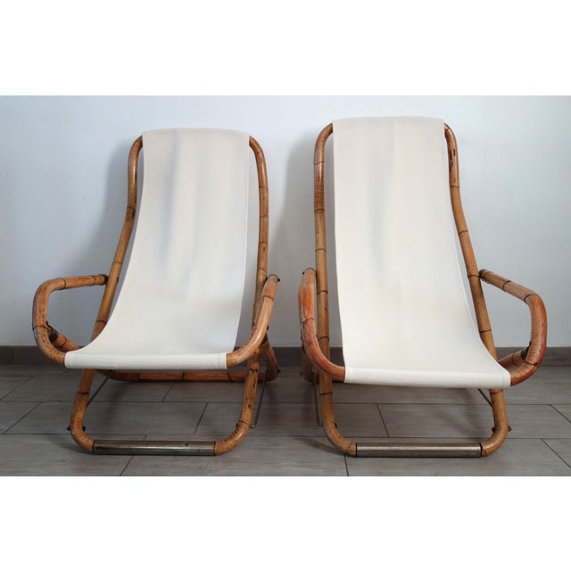 Pair of folding deck chairs from the 1960s, often attributed to the manufacturer Vivai del Sud. Bent bamboo frame, brass...