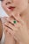 This vintage-style cocktail ring features a striking 3.27-carat oval-cut emerald, set in 14K yellow gold. The center stone...