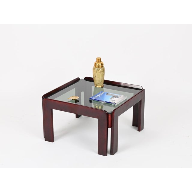 Gorgeous mid-century square coffee table in dark walnut with a smoked glass top. This stylish coffee table was produced in...