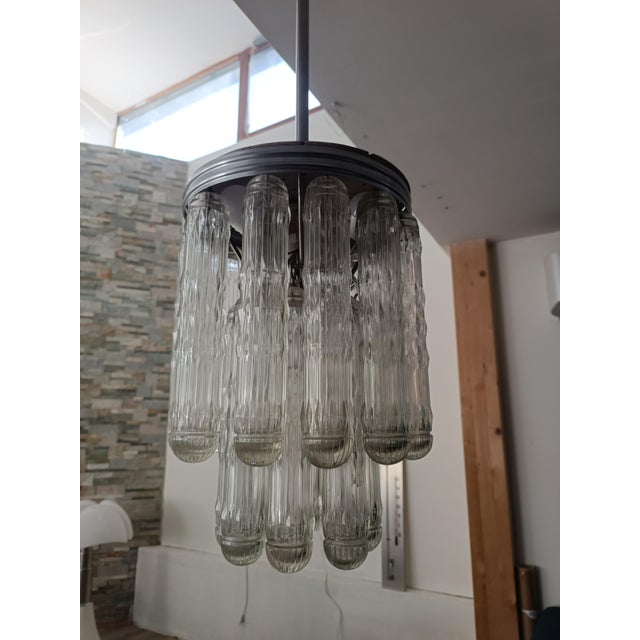 Magnificent and spectacular lighting set by Venini. Italy, 1970s. The chandelier features a chromed metal frame. Suspended...