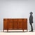 Rounded cherry sideboard. Front with three drawers under the top and three paneled doors, rounded sides with an under-top...