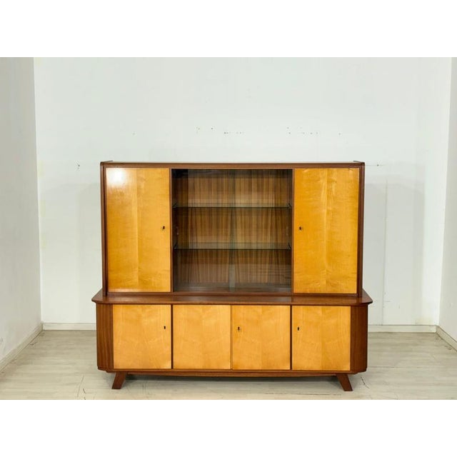 A beautiful vintage highboard, perfect for use as a bar cabinet. This piece of furniture impresses with its elegant design...