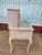 Ornate wooden secretary desk has a light-washed finish with visible wood grain. This piece features a hutch with two side...