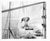 1965 black and white photograph by a St Petersburg, FL photographer of a sailor surrounded by the sails. Publication...