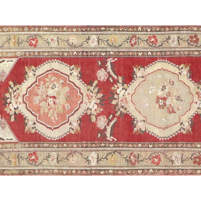 Handwoven vintage Turkish Oushak runner measuring 3'6" x 10'5". Crafted with wool on wool foundation in Western Turkey's...