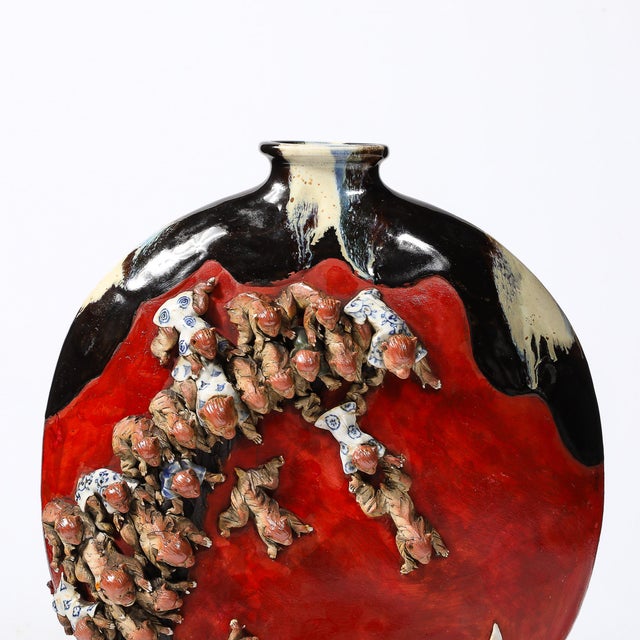 This stunningly rendered Sumida Gawa Pottery Vase in Vermillion Red Glaze W/Clustered Sculptural Primates originates from...