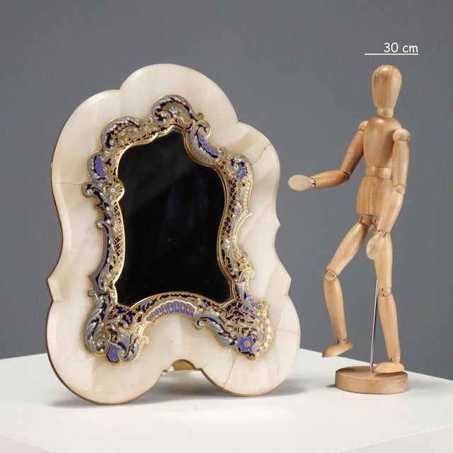 Marble table mirror with rich applied decoration in bronze and polychrome enamels worked with the champlevé and ormolu...