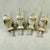 A set of four extremely scarce and unusual sterling silver lemon slice squeezers, Birmingham, England, date marked 1909....