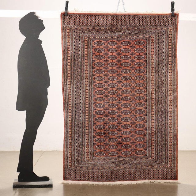 Bukhara rug in cotton and wool. Fine knot; manual manufacturing. This piece is attributed to the mentioned designer/maker....