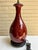 The image displays a Chinese Sang de Boeuf Flambé Oxblood Porcelain Table Lamp. This distinctive piece is characterized by...
