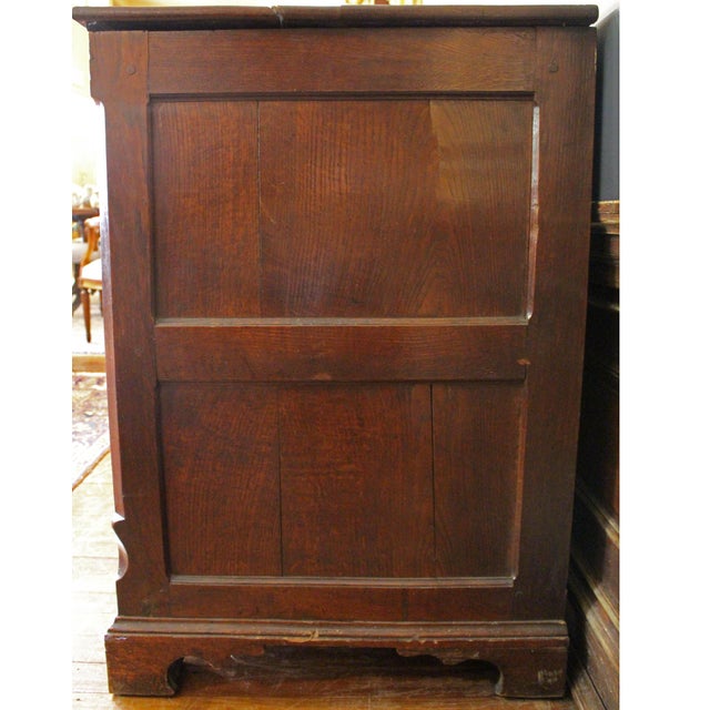 Circa 1765-80 George III period mule chest, English. Oak. Lift top over front of four floating raised panels, flanked by...