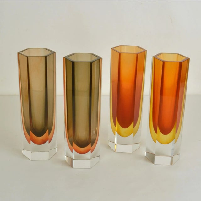 Set of four hand blown and cut tubular vases in burned orange and brown in equal heights in the style of Seguso....