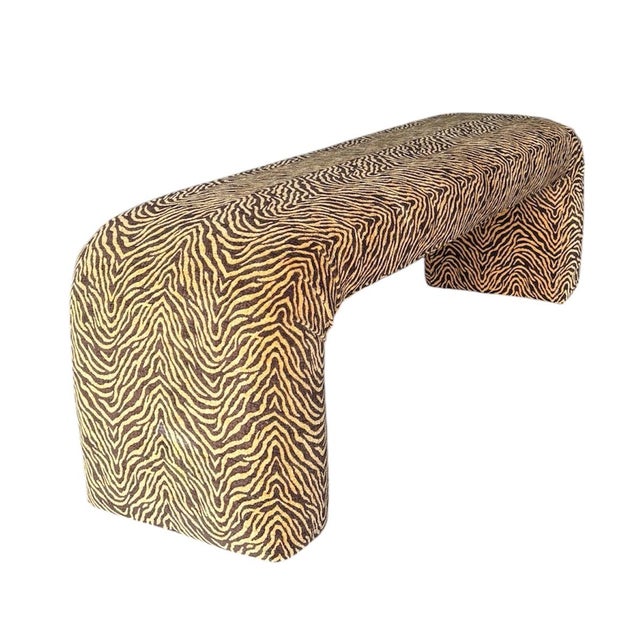 Elegant and minimal, this waterfall bench features a softly arched silhouette and is fully upholstered in a bold tiger...