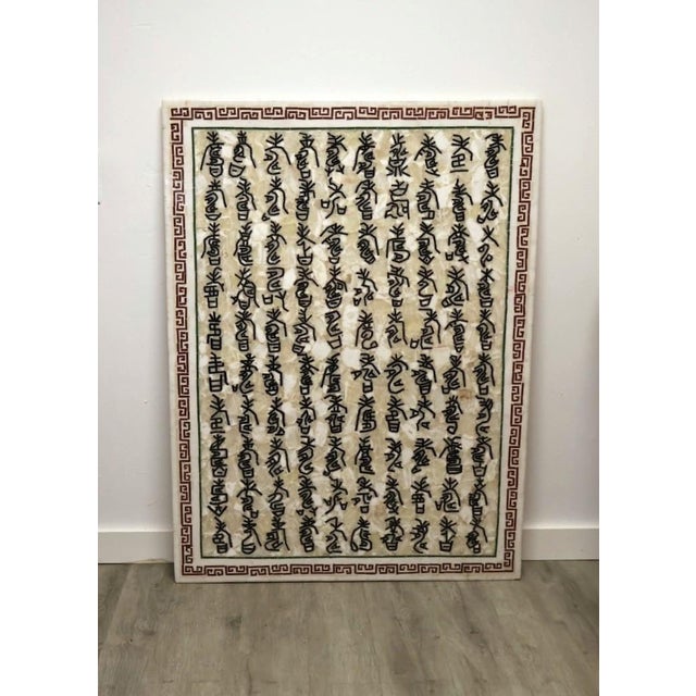 Monumental vintage carved stone wall panel featuring seven vertical rows of deeply incised and darkened symbols framed by...