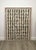 Monumental vintage carved stone wall panel featuring seven vertical rows of deeply incised and darkened symbols framed by...