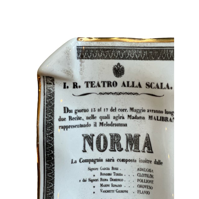 A refined and rare porcelain catchall dish by Fornasetti, Italy, celebrating the iconic opera Norma by Vincenzo Bellini....