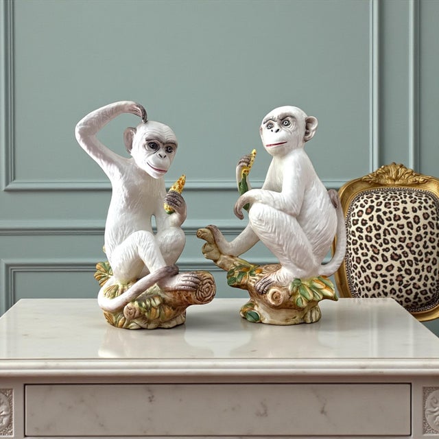 A charming and sculptural pair of mid-century ceramic monkey figures, modeled in expressive seated poses and finished in a...