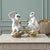 A charming and sculptural pair of mid-century ceramic monkey figures, modeled in expressive seated poses and finished in a...