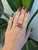 A remarkable 19.91-carat star ruby displays a striking six-rayed star across its large round cabochon, set in solid 14K...