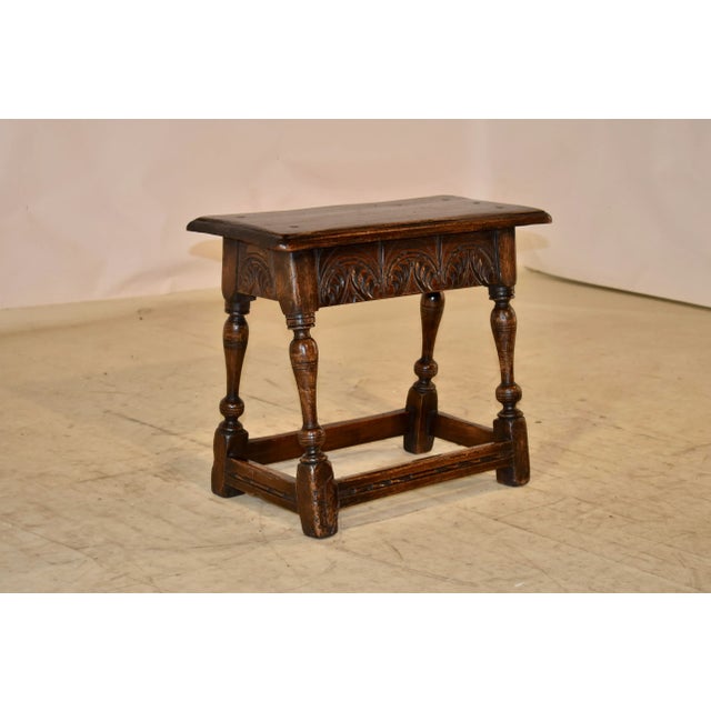 19th century oak joint stool from England with a beveled edge around the top, which is also chamfered and of pegged...