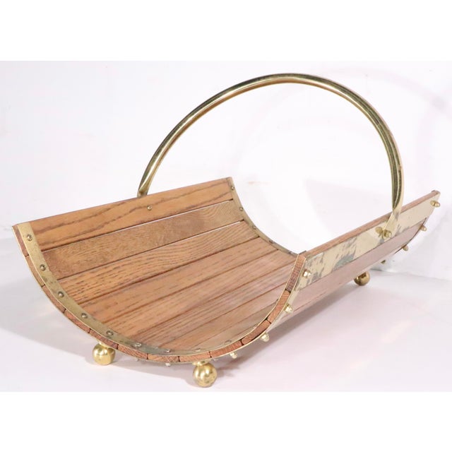 Vintage 1970/80's firewood, log holder, constructed of oak, and brass plated metal , made in Taiwan. The log holder is...