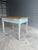 This 19th Century Primitive English Work Table features a distressed light blue painted base and a natural wood top. With...