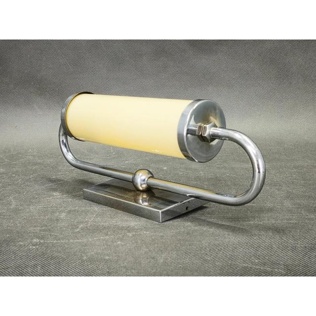 Rare Art Deco wall light produced in Czechoslovakia during the 1930s. This elegant functionalist design combines chrome-...
