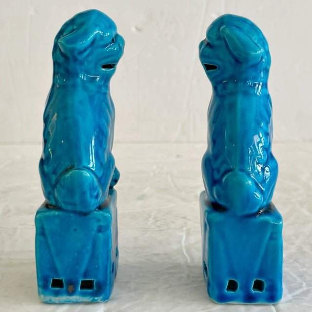 Fabulous pair of small Asian ceramic turquoise foo dogs with both male and female figures. The carving details are...