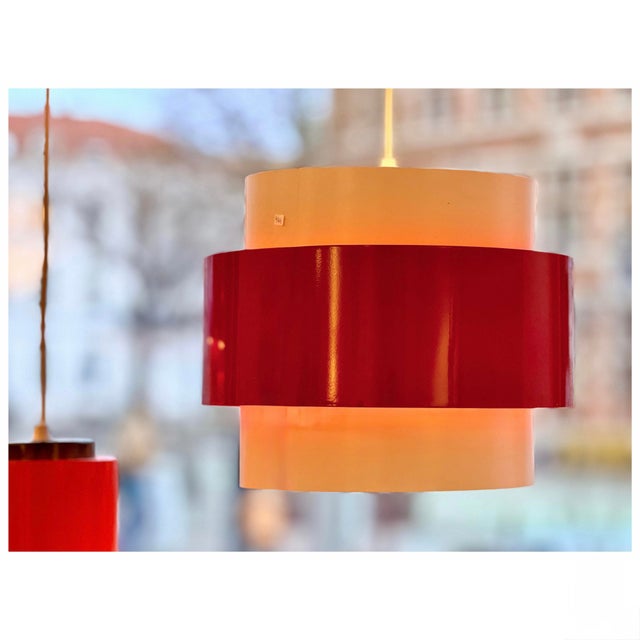 Striking Danish pendant lamp produced in the 1980s. The design combines a translucent white cylindrical diffuser with a...