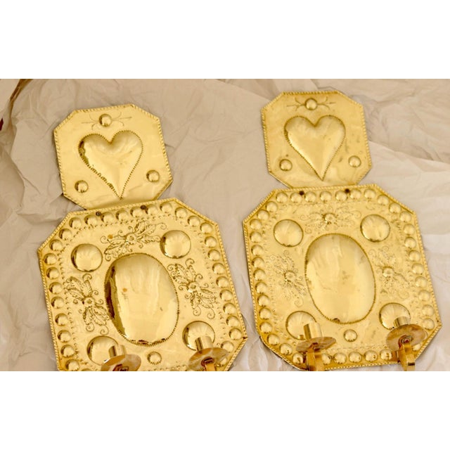 Made in Sweden Mid-century Swedish brass wall sconces, Meticulously handcrafted with embossed designs, the sconce...