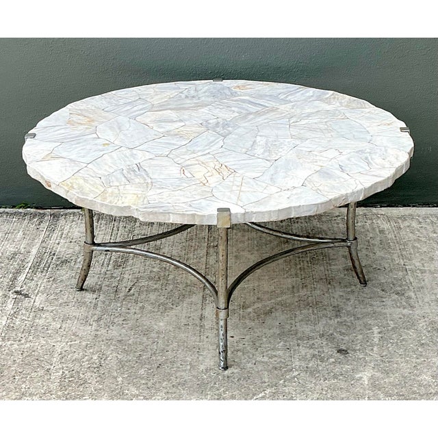 This captivating coffee table is a standout piece of functional art, perfectly blending organic textures with sleek,...