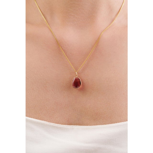 This minimalist pendant features a beautiful 3.33 ct natural pink tourmaline, set in 14k yellow gold. The center stone has...