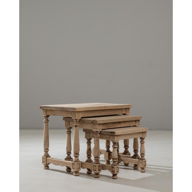 This set of three 20th Century French wooden nesting tables features a beautifully cohesive design defined by turned legs,...