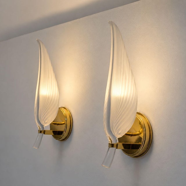 Elegant pair of Italian wall sconces by Franco Luce, dating from the 1970s and crafted with Murano glass leaf-shaped...