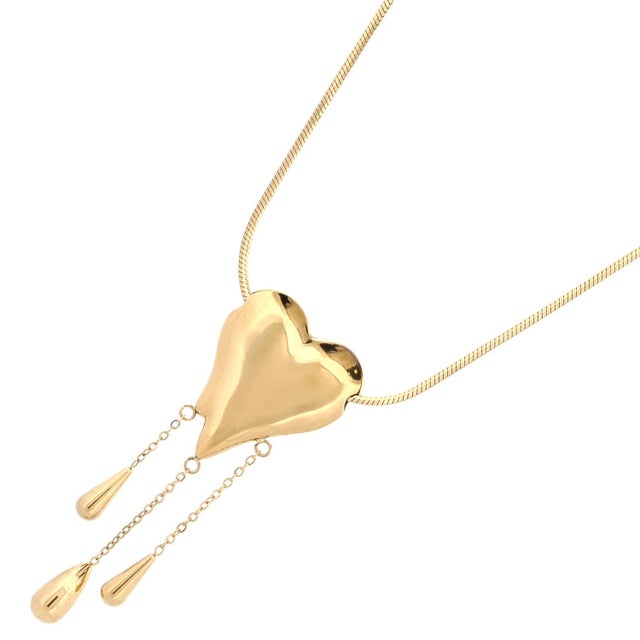 Express elegance and emotion with our Golden Tears of Love Necklace. Featuring a polished heart pendant adorned with three...
