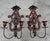 Pair of antique Spanish Revival cast iron wall sconces with a richly aged brown and black painted finish. Featuring...