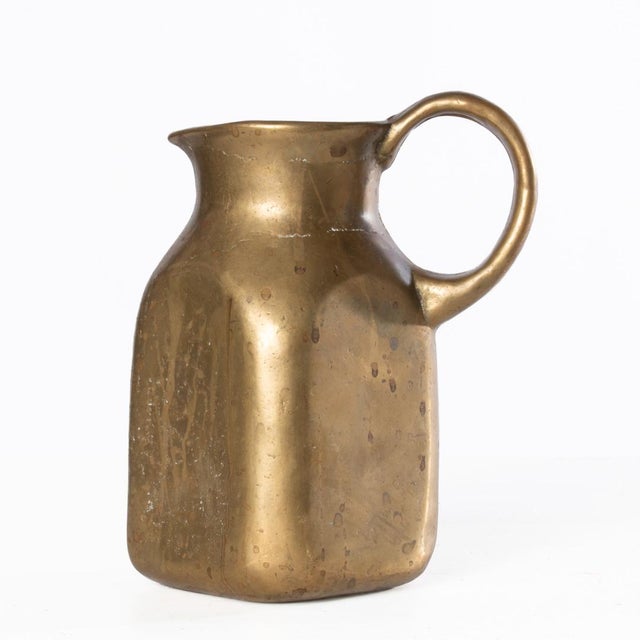 Solid brass or bronze pitcher, not sure if this is brass or bronze but it is solid. Great piece to display in a kitchen or...