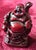 A striking miniature Laughing Buddha (Budai), exquisitely hand-carved from carnelian (red chalcedony) and finished to a...