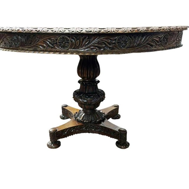 A handsome antique Burmese dining table crafted in richly figured hardwood, most likely teak, dating to circa 1840 The...
