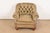 An outstanding late Victorian leather upholstered deep tufted club chair or tub chair with scrolled arms on turned bun...